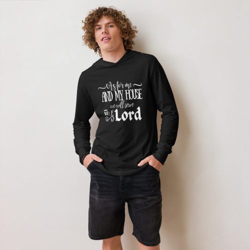 A young man with curly hair stands against a neutral background, wearing the "As For Me We Will Serve The Lord" hoodie in black. He pairs it with dark shorts, and his hands are tucked into his pockets. christian gifts, religious gifts, gifts of faith, faith based gifts, faith inspired gifts